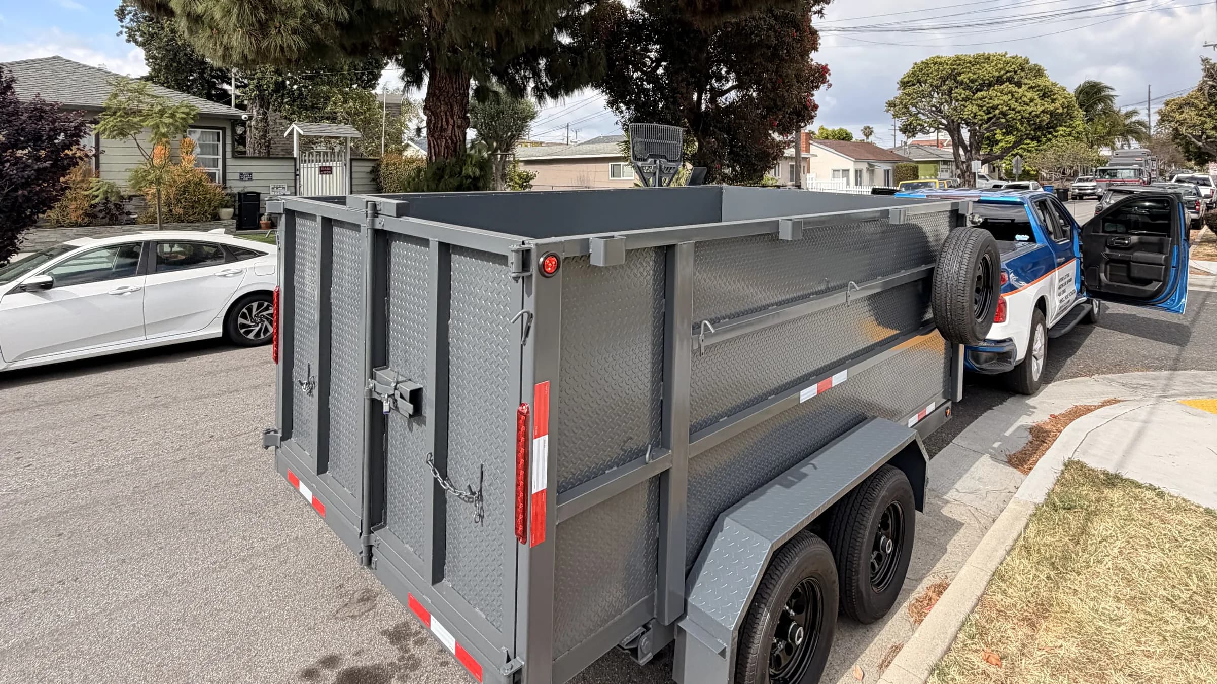 Paragon dump trailer on-site for a South Bay junk removal job — 12 cubic yards of capacity